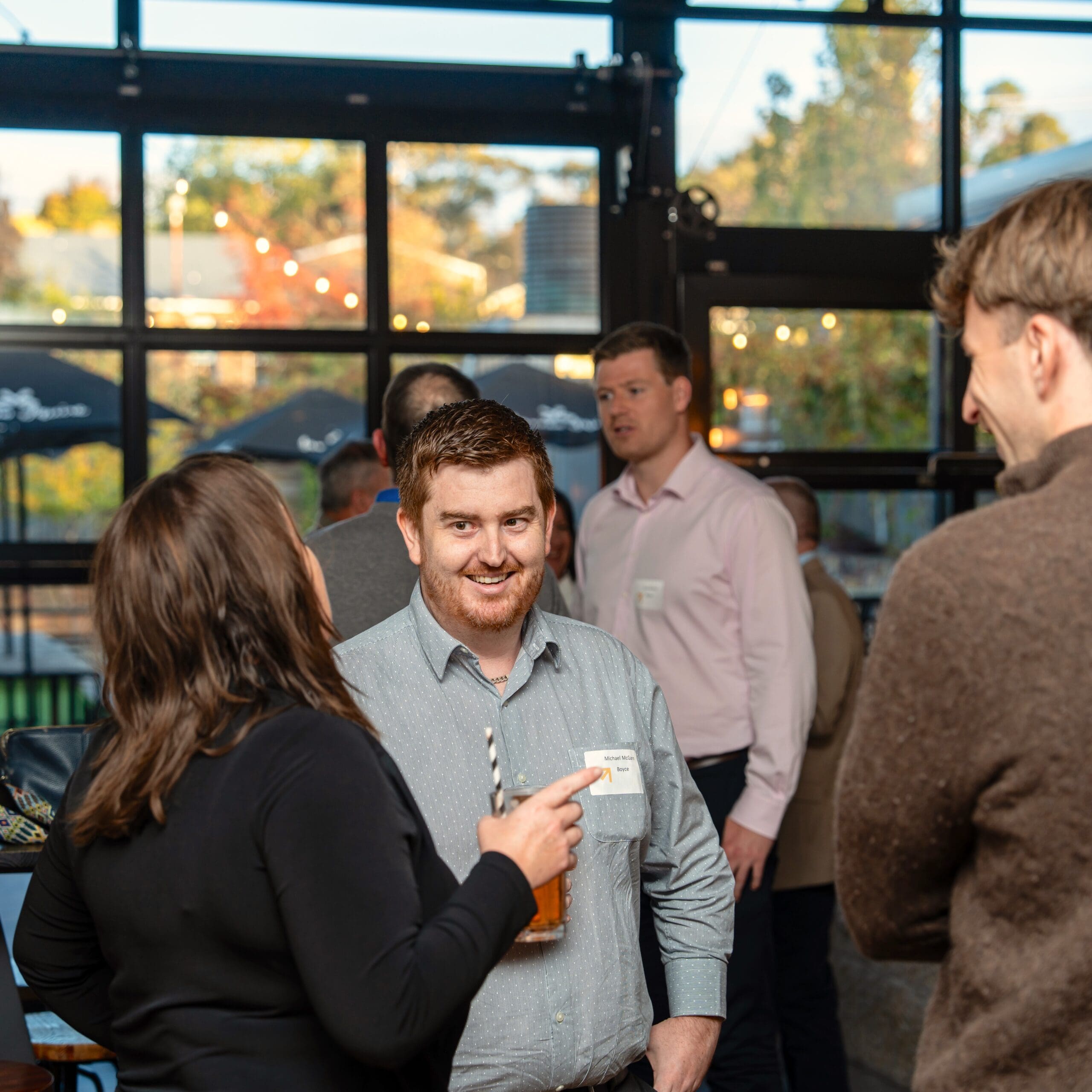 man smiling with colleague