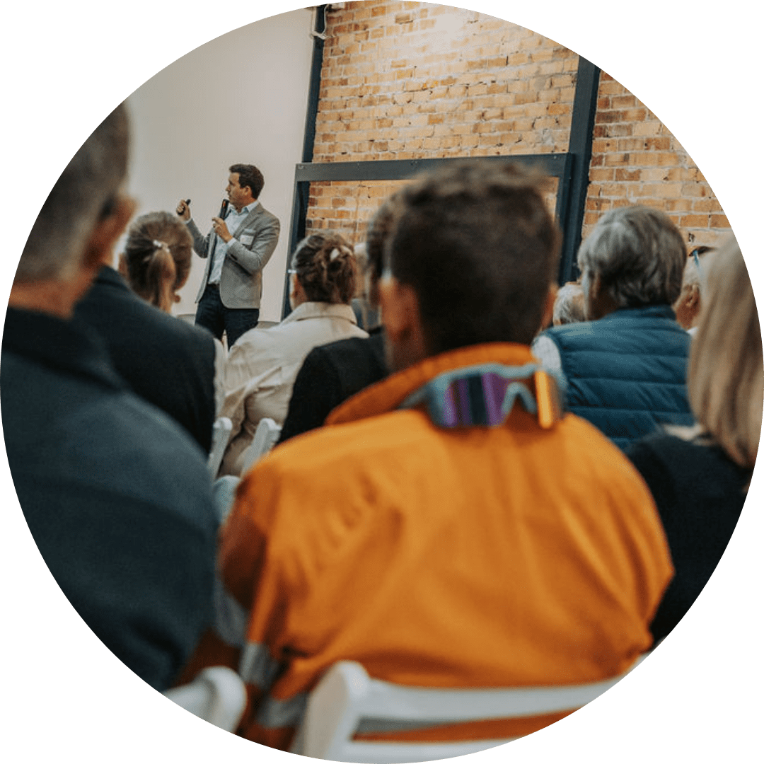 man delivering financial advice to diverse audience